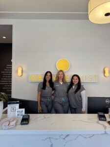 staff posing behind desk 1 Dallas - Mockingbird Station