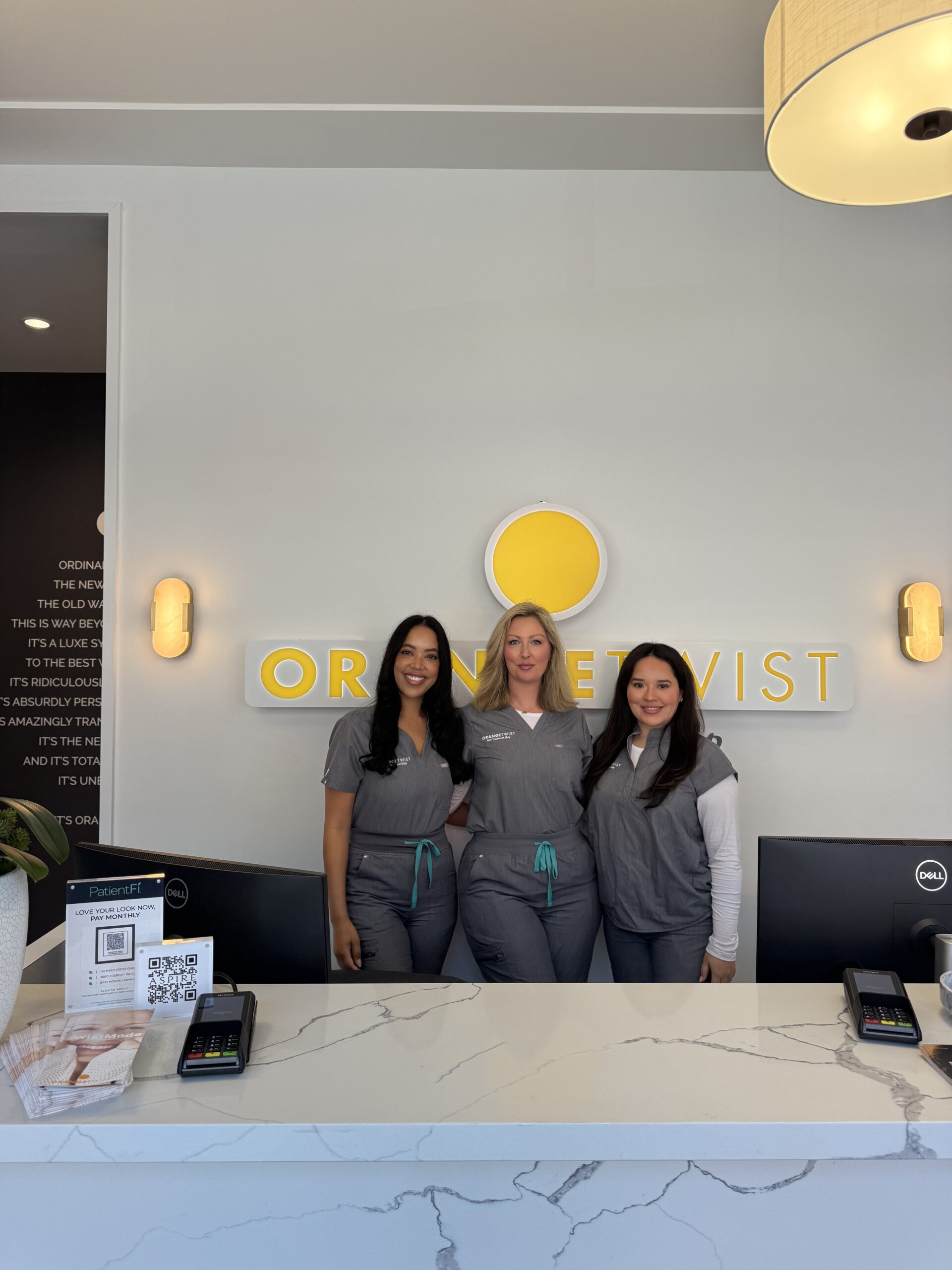 staff posing behind desk scaled Fort Worth - Alliance Town Center