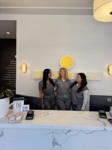 staff smiling behind desk Dallas - Mockingbird Station