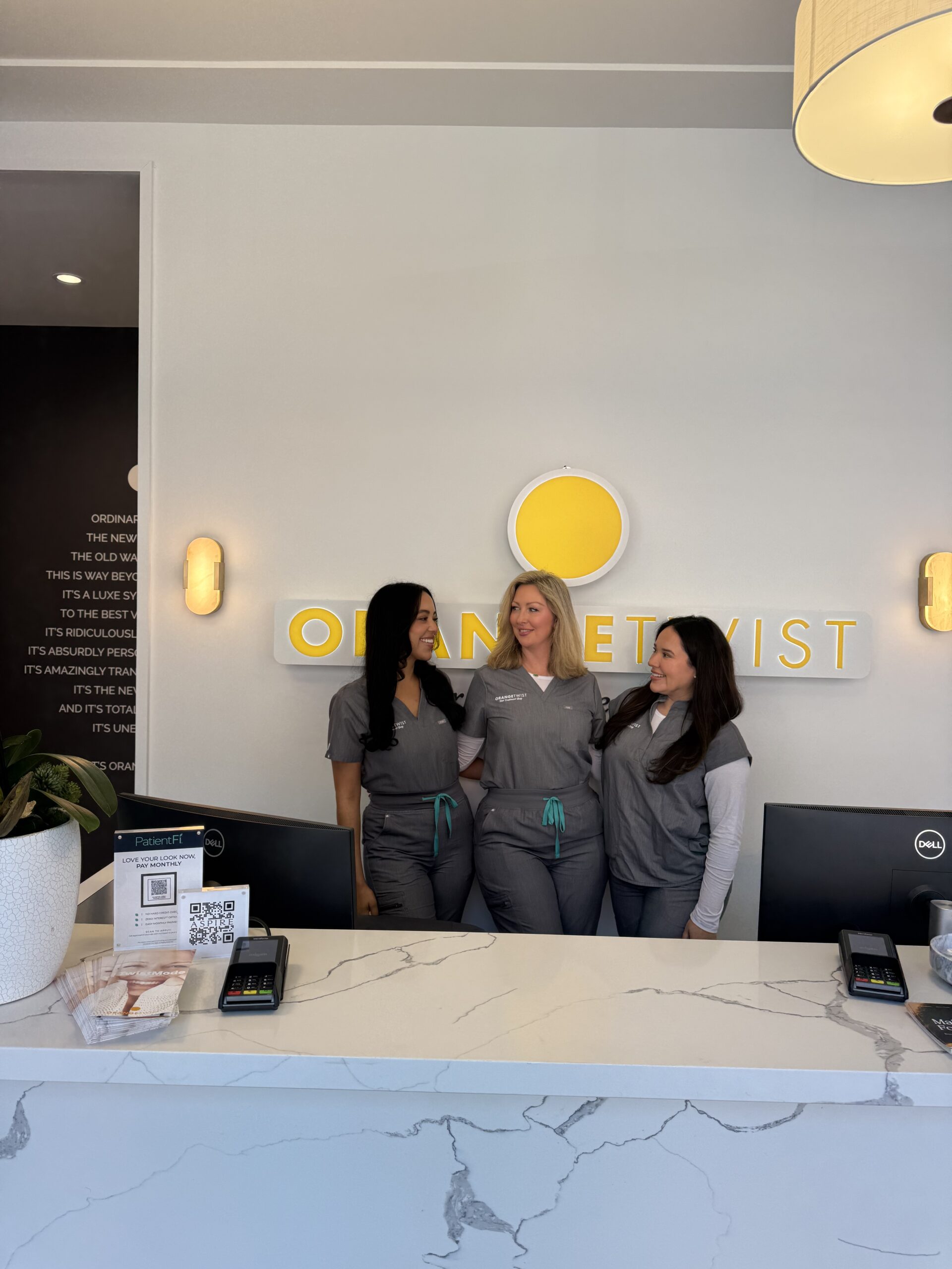 staff smiling behind desk scaled Dallas - Mockingbird Station