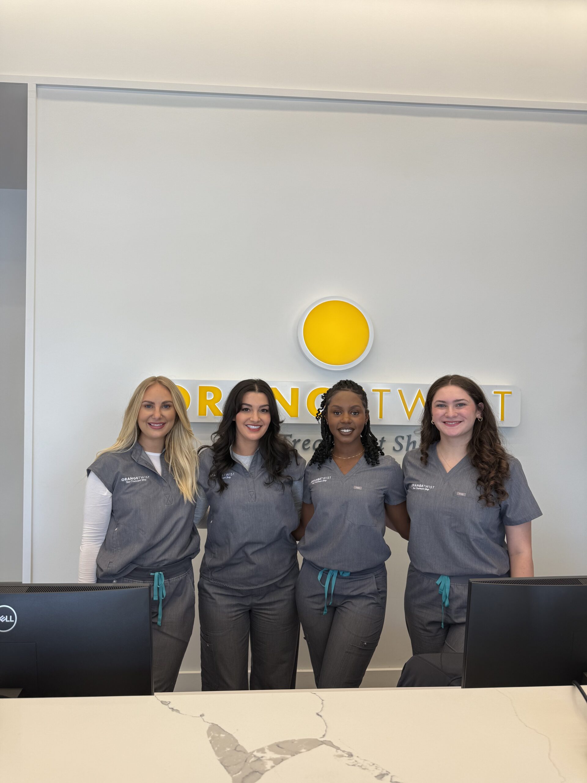 team behind desk scaled Highland Village