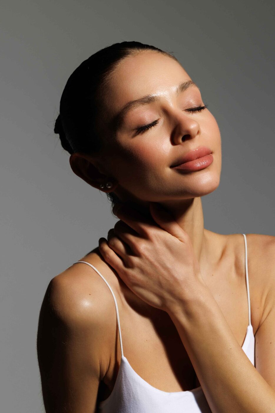 Woman with glowing skin relaxing in the studio